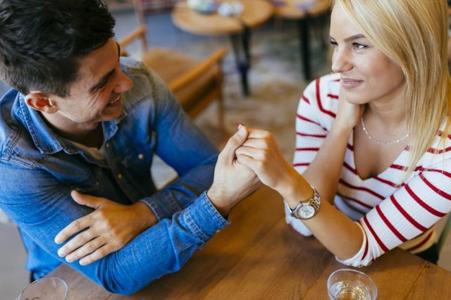 Beautiful couple in love flirting in restaurant and bonding