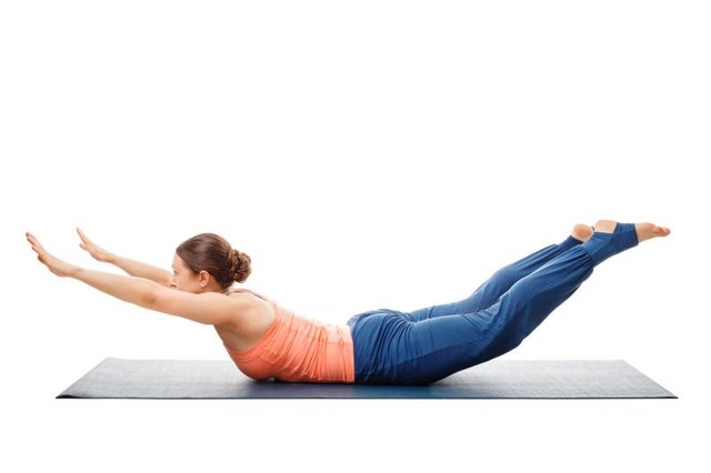 Woman doing Ashtanga Vinyasa Yoga asana Salabhasana A - locust pose A isolated on white background