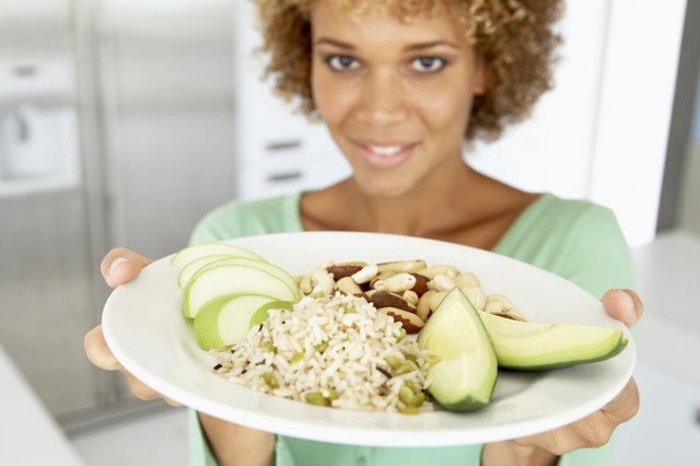 Mid Adult Woman Holding A Plate With Healthy Food