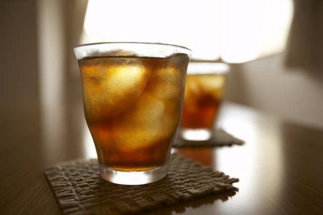 Glasses of iced tea on table, close up, differential focus