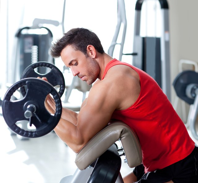 man with weight training equipment on sport gym