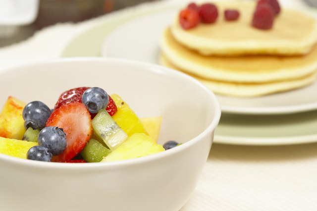 Fresh fruit in bowl and on pancakes