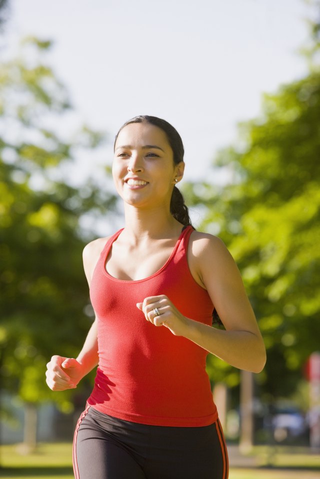 Hispanic woman jogging in park