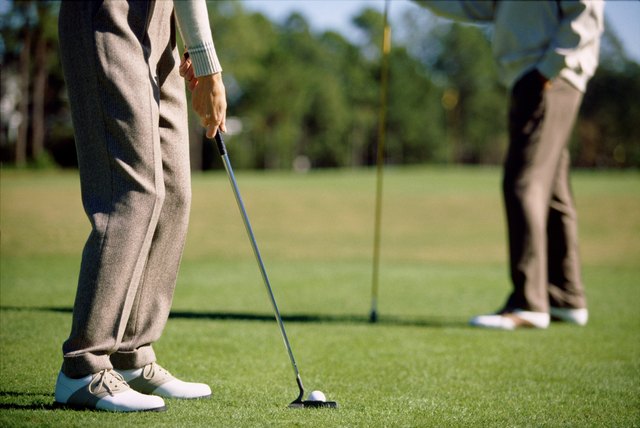 Low section view of two people playing golf