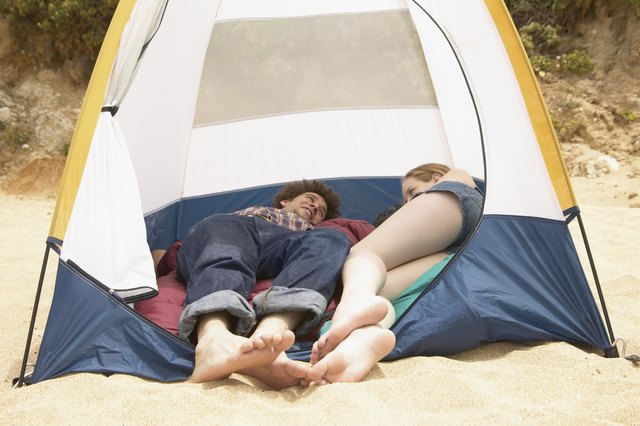 Teenage couple lying in a tent