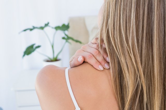 Rear view of woman getting neck pain