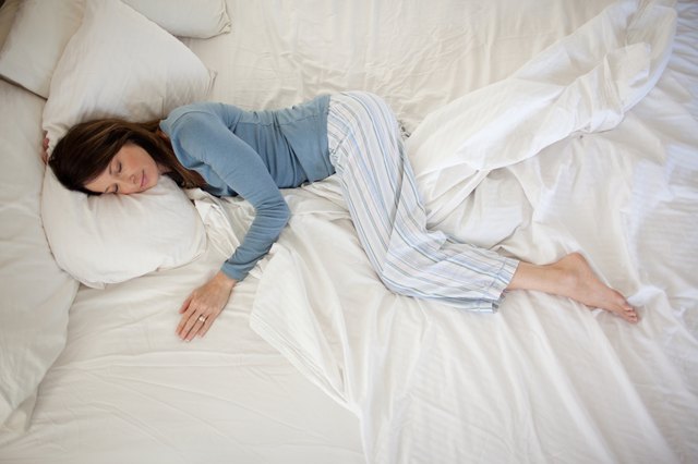 middle aged woman sleeping in bed