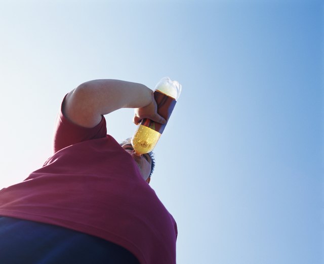 Overweight Teenage Man Drinking From a Bottle