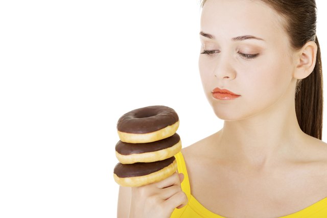 Woman with a pile of doughnuts.