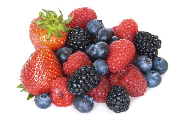 Mixed berries - strawberries, raspberries, blackberries and blueberries on white