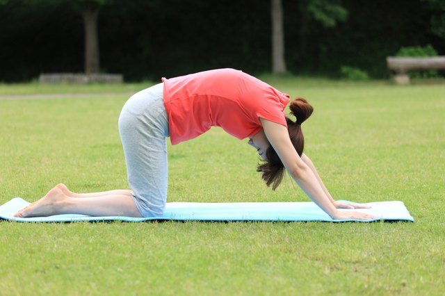 Japanese woman doing yoga cat pose