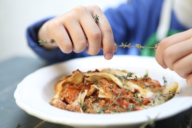 Boy preparing lasagna