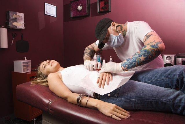 Woman getting pierced.