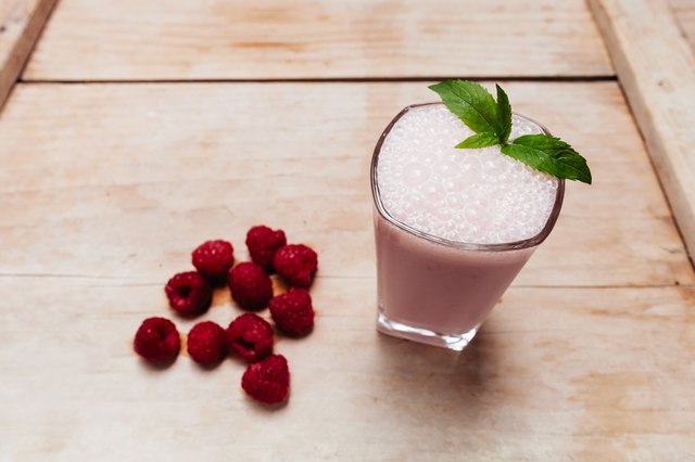 Raspberry smoothie fresh blended on summer wood table