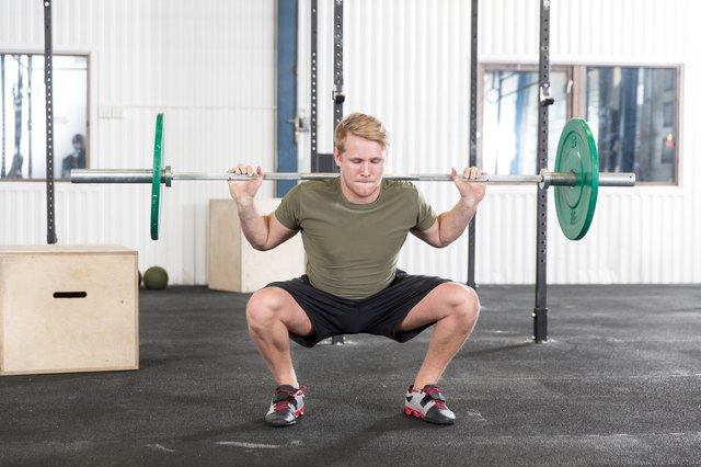 Squats training at fitness gym center