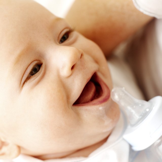 close up view of a mother bottle feeding her baby (6-12 months)