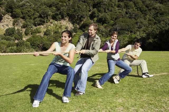 Friends playing tug-of-war in park