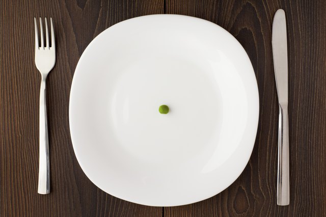 One pea on a white plate