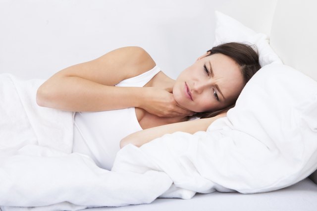 Sick Woman Lying In Bed