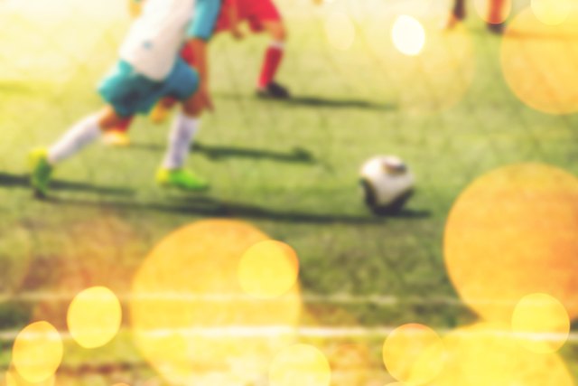 Blurred children playing soccer, retro tonedr