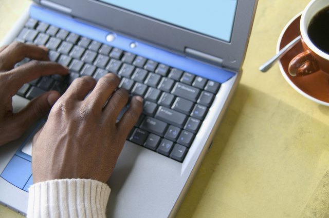 High angle view of young man operating a laptop