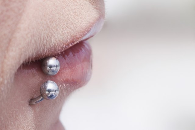 Profile of young woman's pierced lip, extreme close-up