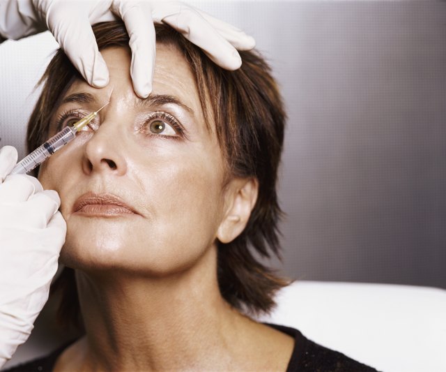 Mature Woman Receiving an Injection to Her Forehead