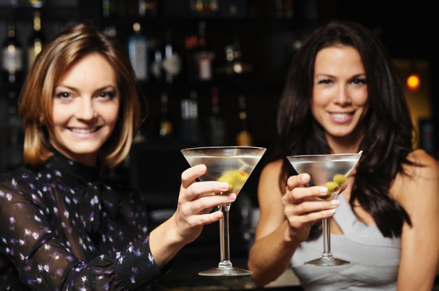 Two Young Women Toasting Drinking Martinis in Bar