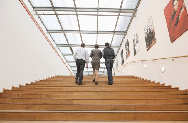 Three business people going upstairs