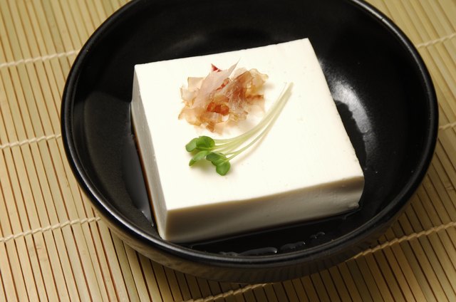 Block of tofu served with a garnish