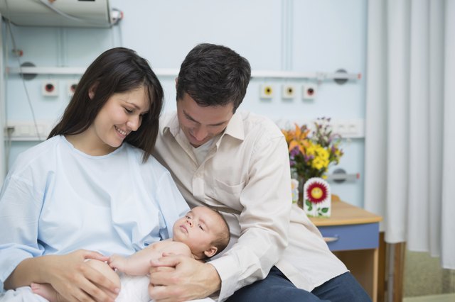 Father and mother holding a new born baby