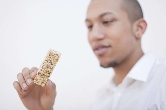 Young African-American Man Eating Cereal Bar