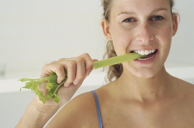 Young woman eating lettuce