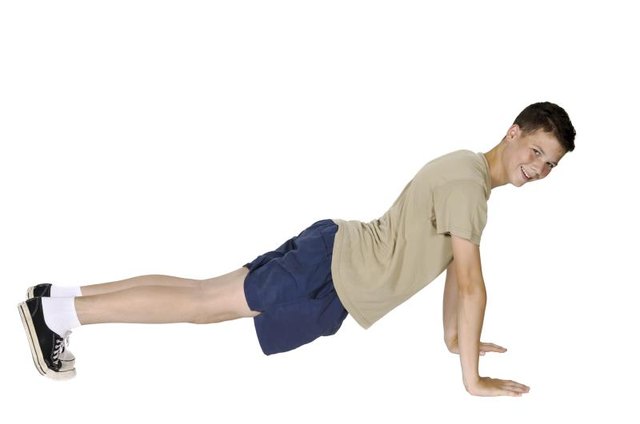Young man in pushup position isolated with white background