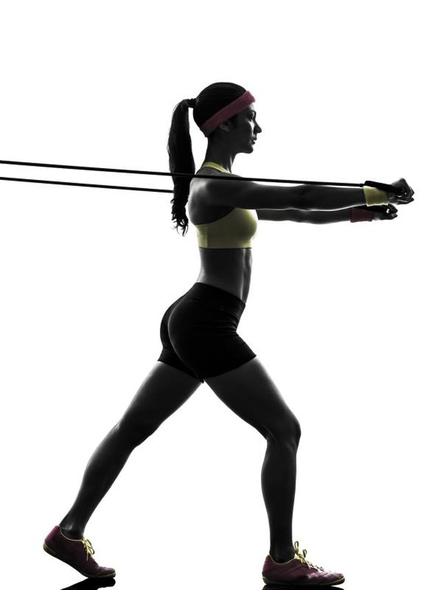 one woman exercising fitness workout resistance bands in silhouette on white background