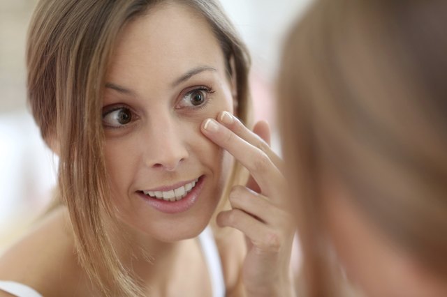 Brunette woman taking care of skin