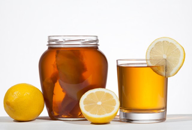 Kombucha super food pro biotic beverage in glass with lemon