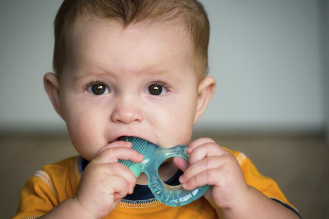 Baby chewing on teething ring