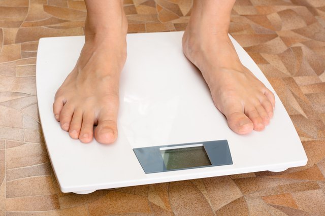 pair of female feet standing on the scale