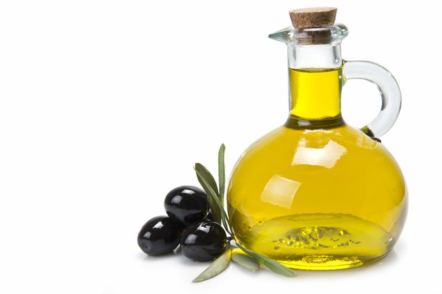 Jar with olive oil and black olives.