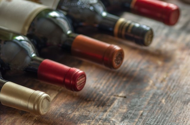 Row of wine bottles on wooden background