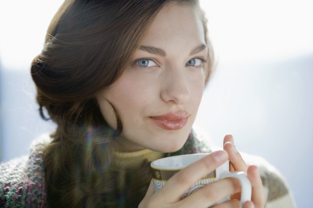 Portrait of young woman drinking coffee