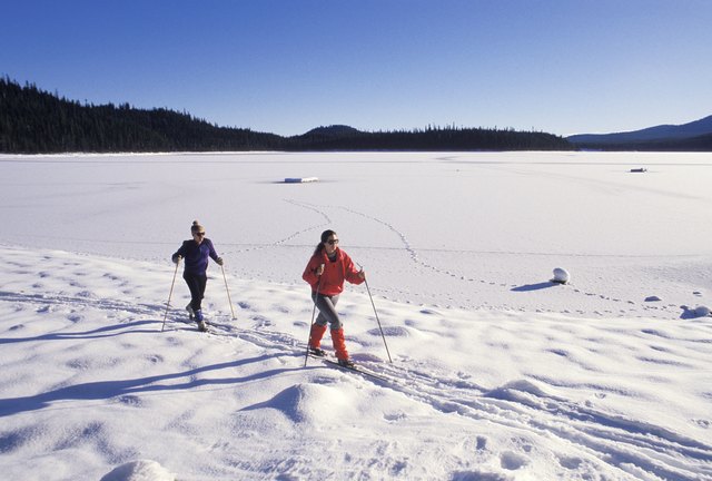 Two people skiing in a ski resort