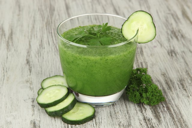 Green vegetable juice on table close-up