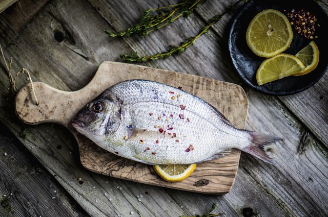 Fresh sea bream on wooden board