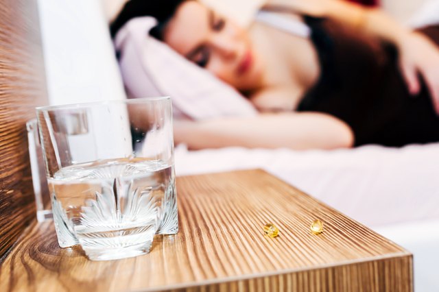 Pregnant woman resting with pills at hand