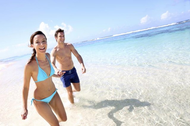 Couple running on a sandy beach