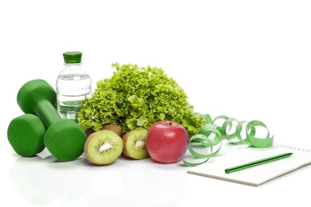 healthy eating, diet and weight loss, detox . dumbbells, kiwi and a bottle of water