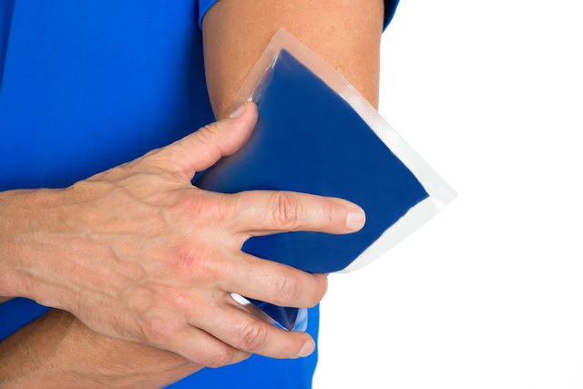 Hand Holding Ice Gel Pack On Elbow