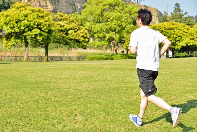 Japanese middle age man running in a park